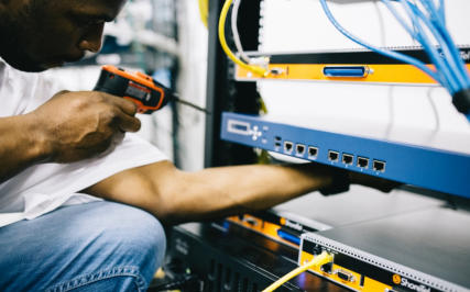 Photo of man using a tool to check some equipment