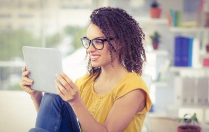 Photo of young woman looking at a tablet