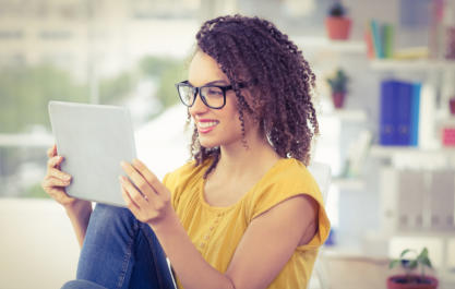 Photo of young woman looking at a tablet